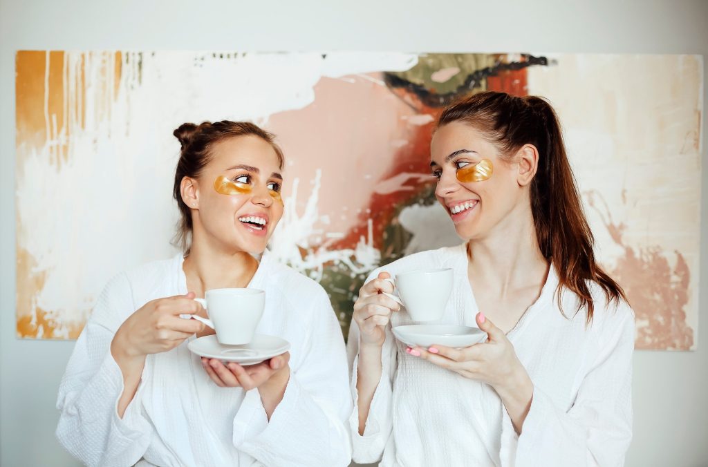 Young girls in bathrobes and eye patches. guests in hotel