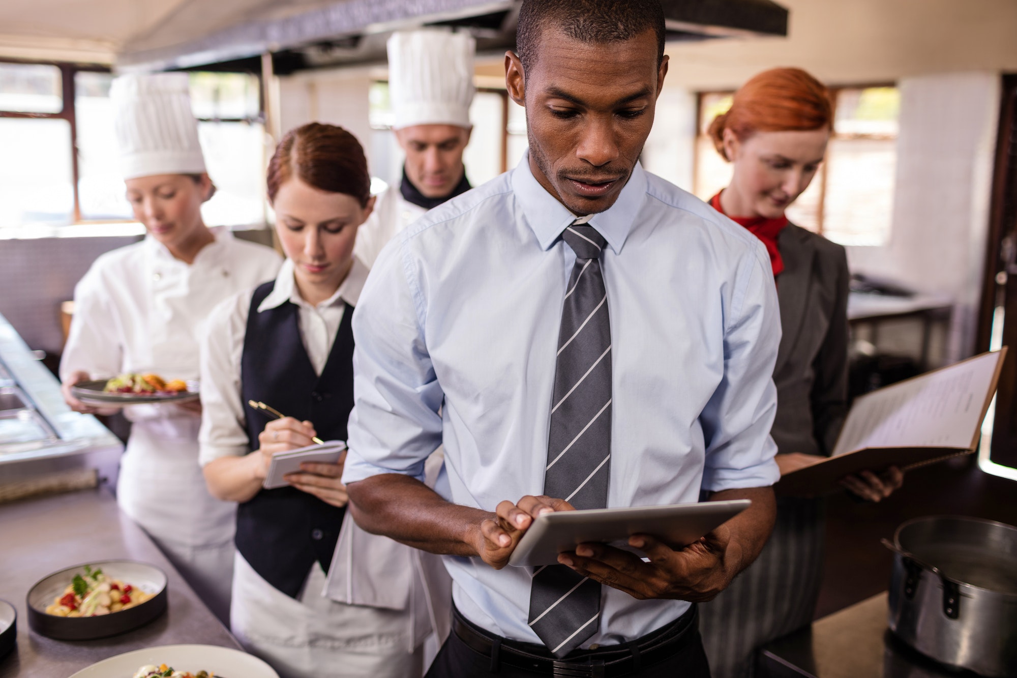 Group of hotel staffs working in kitchen