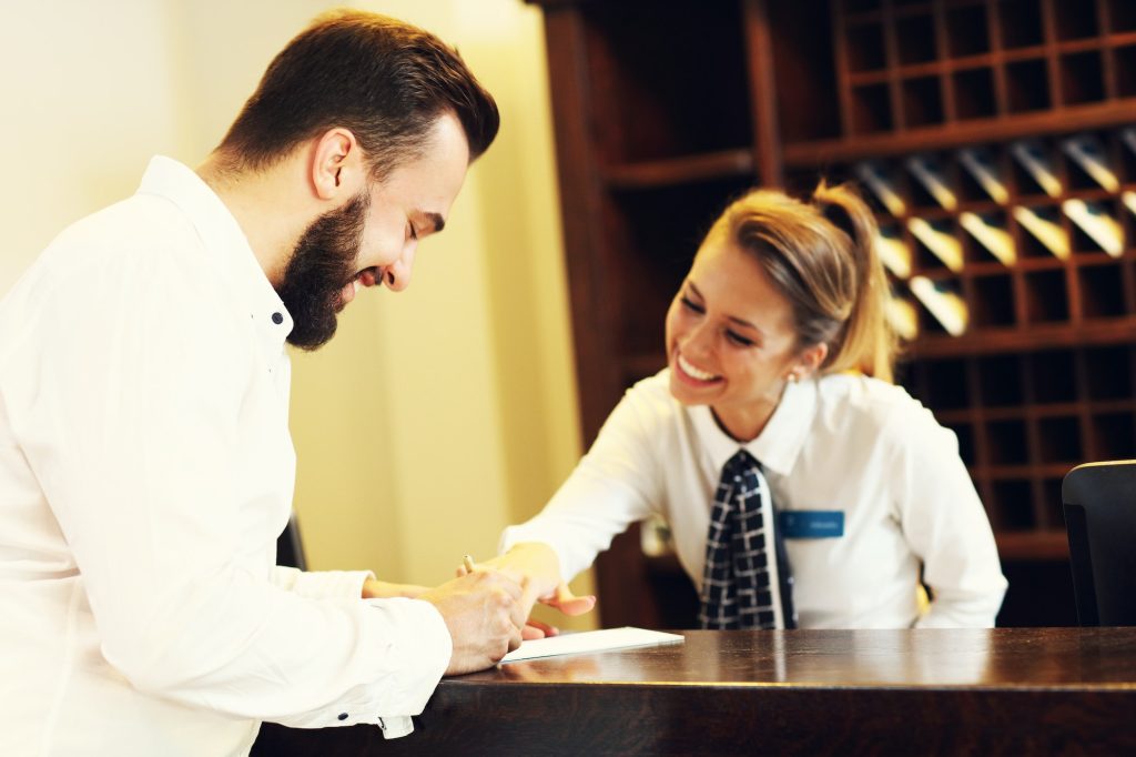 Man signing bill in hotel no hidden fees